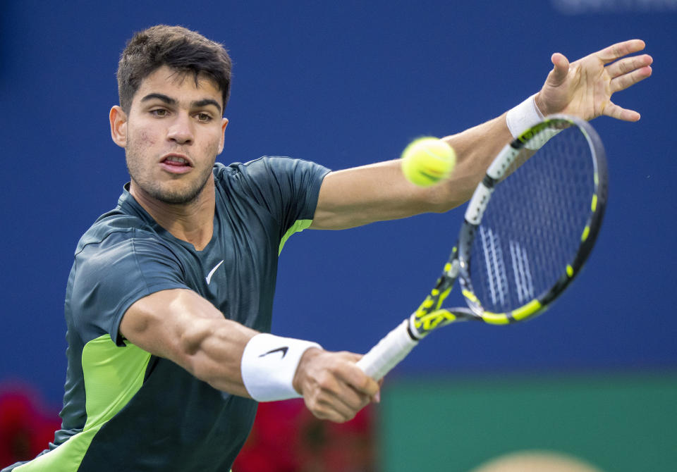 FILE - Carlos Alcaraz, of Spain, hits a return to Tommy Paul, of the United States, during the National Bank Open men's tennis tournament Friday, Aug. 11, 2023, in Toronto. Alcaraz is one of the men to watch at the U.S. Open, which begins at Flushing Meadows on Aug. 28.(Frank Gunn/The Canadian Press via AP, File)