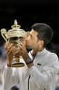 FILE - In this July 14, 2019, file photo, Serbia's Novak Djokovic kisses the trophy after defeating Switzerland's Roger Federer in the men's singles final match of the Wimbledon Tennis Championships in London. Federer leads the list with 20 Grand Slam singles titles. Rafael Nadal has 19. Djokovic has 16. (AP Photo/Tim Ireland, File)