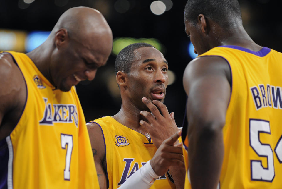 Kobe Bryant tries to talk some sense into Kwame Brown. (AP)