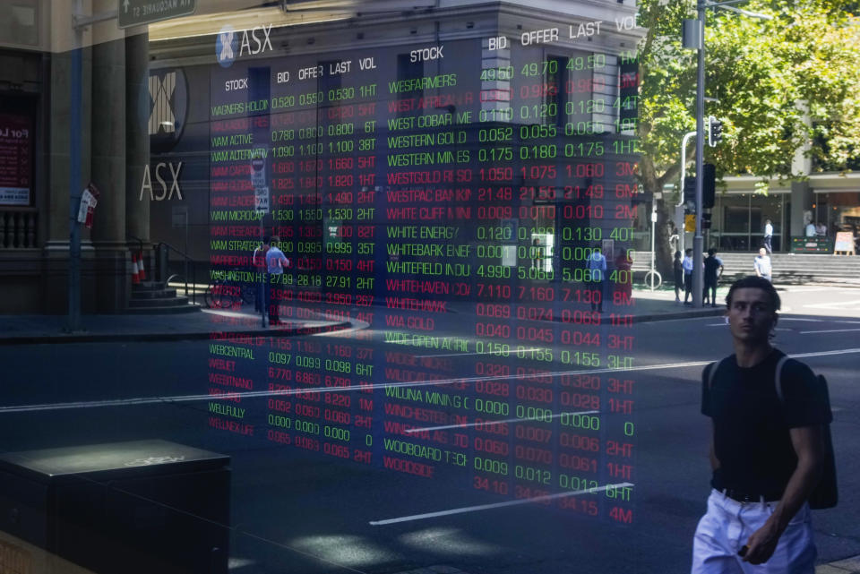 People are reflected in the window of the Australian Stock Exchange in central Sydney, Australia, Thursday, March 16, 2023. Asian stock markets tumbled Thursday after Wall Street sank as a plunge in Credit Suisse shares reignited worries about a possible bank crisis following the failure of two U.S. lenders. (AP Photo/Mark Baker)