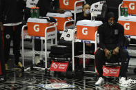 Los Angeles Clippers forward Kawhi Leonard watches the game from the bench during the first half of an NBA basketball game against the Dallas Mavericks in Los Angeles Sunday, Dec. 27, 2020. (AP Photo/Kyusung Gong)