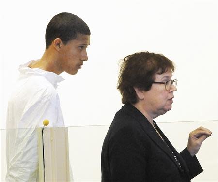 Philip Chism, 14, stands during his arraignment for the death of Danvers High School teacher Colleen Ritzer in Salem District Court in Boston, Massachusetts October 23, 2013 as his attorney Denise Regan (R) speaks on his behalf. Chism was held without bail on a murder charge. REUTERS/Patrick Whittemore/Pool