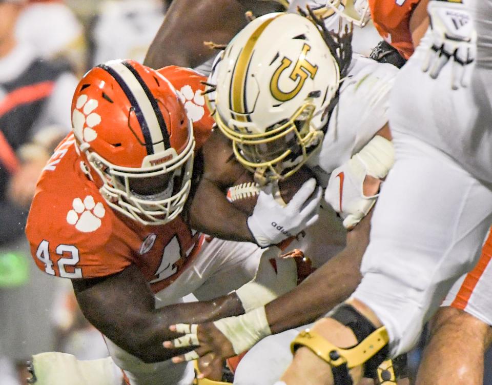 Clemson linebacker LaVonta Bentley (42) tackles Georgia Tech freshman Jahmyr Gibbs (1) during the fourth quarter in Clemson, S.C., September 18, 2021. 