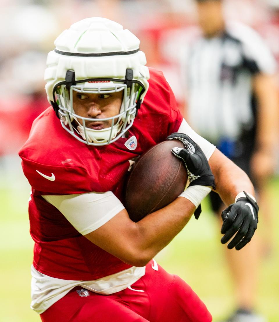 TE Noah Togiai runs with the ball during the Arizona Cardinals’ annual Red & White practice at State Farm Stadium in Glendale on Aug. 5, 2023.