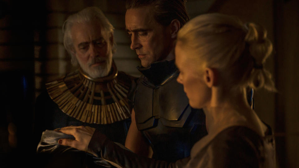 Terrence Mann, Lee Pace, and Laura Birn examining something in a dim room in Foundation.