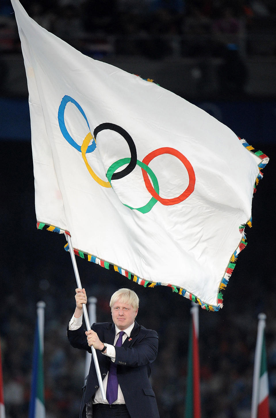 Mayor of London Boris Johnson clenches waving the Olympic Flag during the Closing Ceremony at the National Stadium during the 2008 Beijing Olympic Games, China.