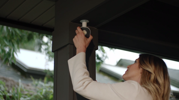 Woman installing Arlo security light