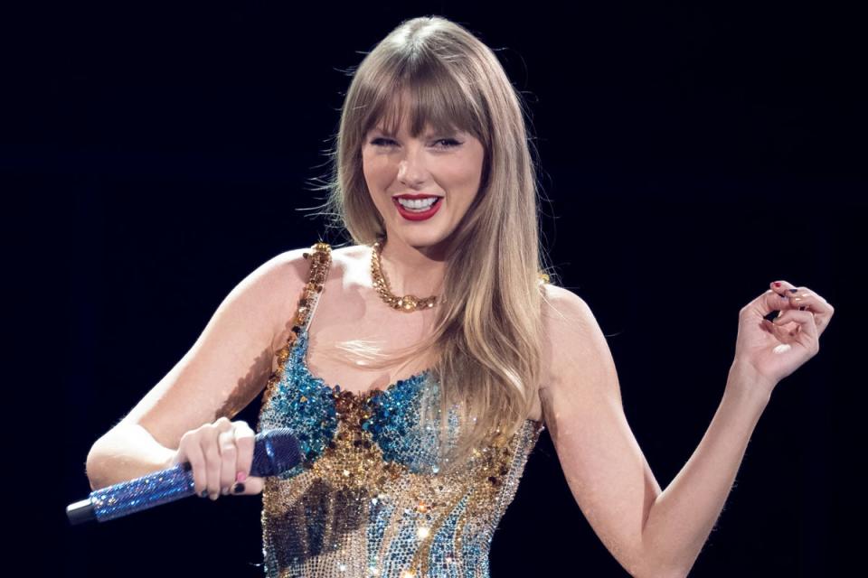 Swift performing onstage on the first night of her Eras Tour at AT&T Stadium in Arlington, Texas, on March 31, 2023 (AFP via Getty Images)