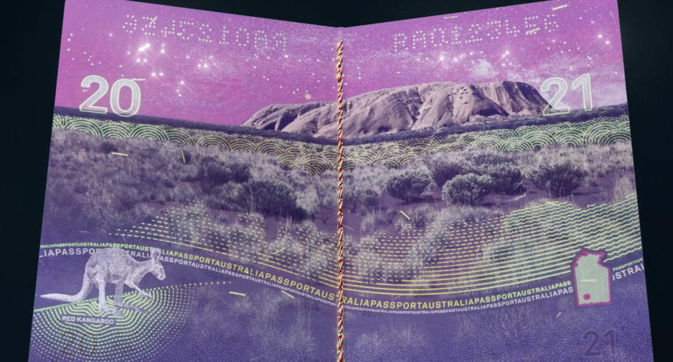 A photo of one of the visa pages of the new Australian passport that has an illustration of Uluru and a kangaroo at the bottom left, which can only be seen under ultraviolet light.