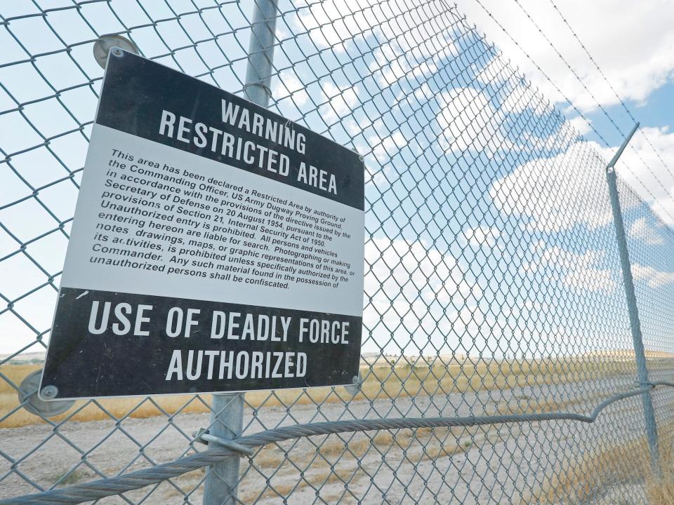 A warning sign authorizing the use of deadly force hangs on a fence line surrounding the U.S. Army's Dugway Proving Ground in 2017.