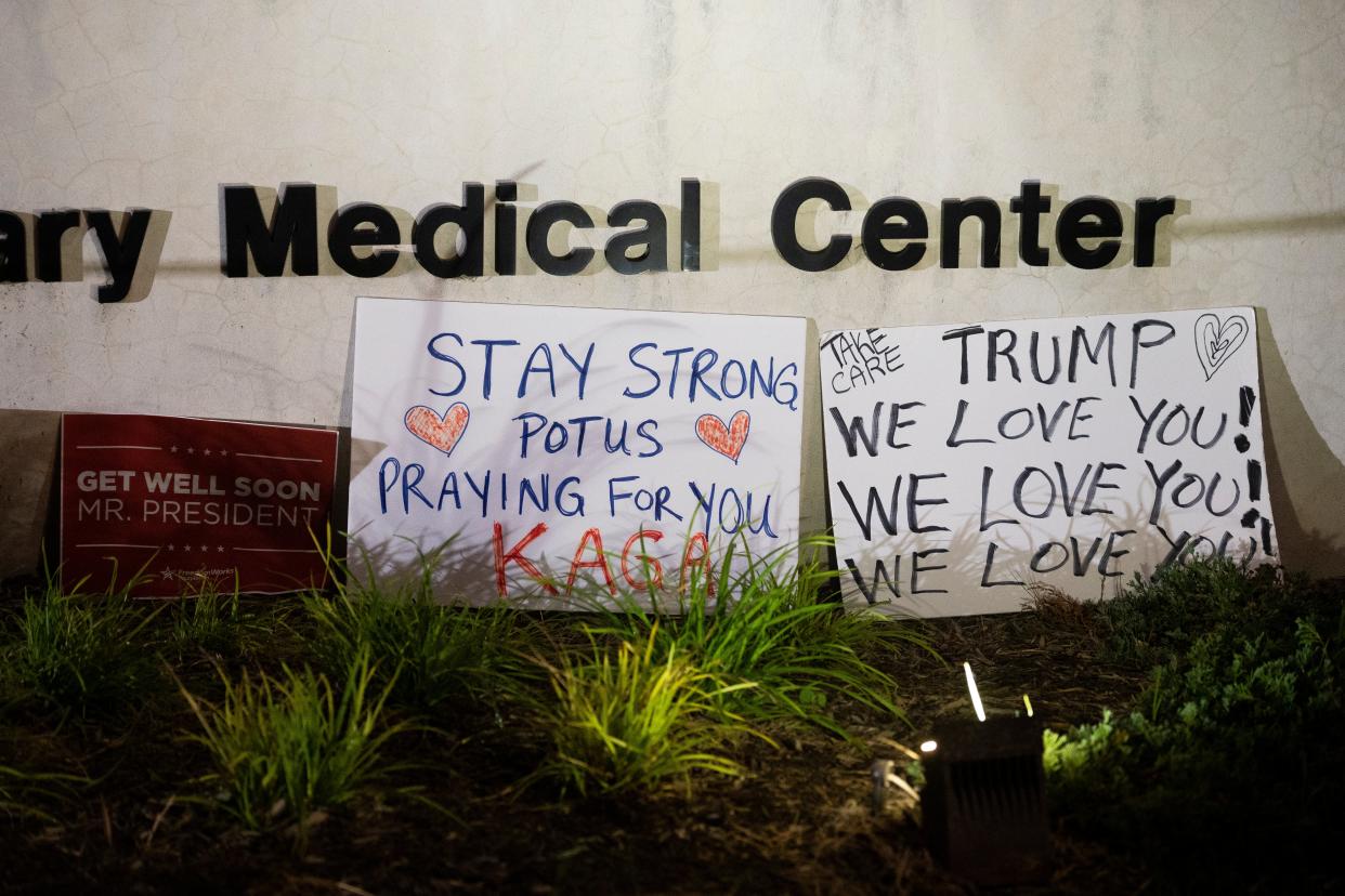 Signs left by supporters of President Donald Trump at the entrance to Walter Reed National Military Medical Centre (AP)