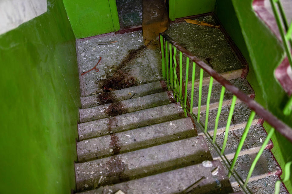 Blood stains mark the stairs inside a building damaged in an overnight missile strike in Sloviansk, Ukraine, Tuesday, May 31, 2022. (AP Photo/Francisco Seco)