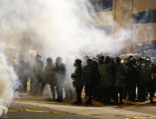 Police and protesters square off outside the Richmond Police Department headquarters on Grace Street in Richmond, Va., Saturday, July 25, 2020. (Joe Mahoney/Richmond Times-Dispatch via AP)