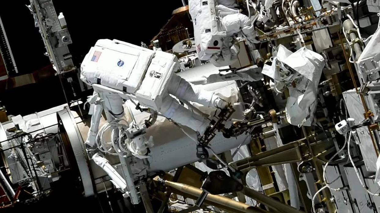  Astronauts perform a spacewalk outside the International Space Station. 