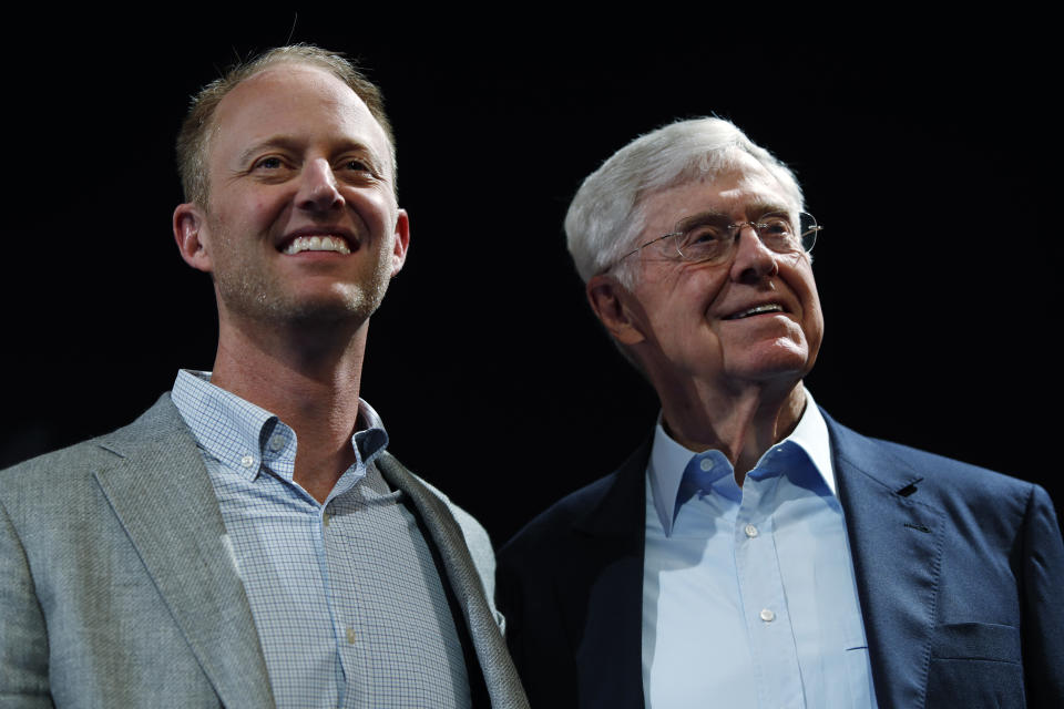 In this Saturday, June 29, 2019, file photograph, Charles Koch, chief executive officer of Koch Industries, right, is shown with his son, Chase Koch, at The Broadmoor Resort in Colorado Springs, Colo. (AP Photo/David Zalubowski)