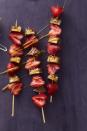 <p>Instead of giving your partner their favorite candy bar in the cute pink and red holiday wrapping paper this Valentine's Day, turn it into this chocolatey-fruity kebab. </p><p><em><a href="https://www.womansday.com/food-recipes/food-drinks/recipes/a59413/strawberry-snickers-sticks-recipe/" rel="nofollow noopener" target="_blank" data-ylk="slk:Get the Strawberry and Snickers Sticks recipe.;elm:context_link;itc:0;sec:content-canvas" class="link ">Get the Strawberry and Snickers Sticks recipe.</a></em></p>