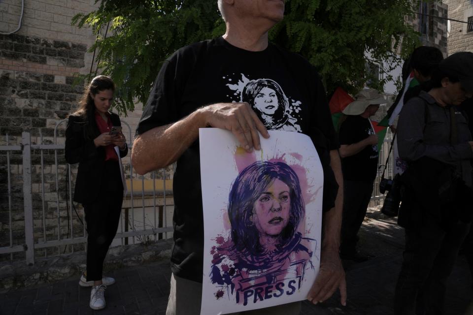 Protesters hold posters for slain Palestinian-American journalist Shireen Abu Akleh near the Augusta Victoria Hospital in east Jerusalem ahead of a visit by U.S. President Joe Biden, Friday, July 15, 2022. The protesters said they are seeking justice in the killing of Abu Akleh, who was shot dead while covering an Israeli military raid in the occupied West Bank in May.