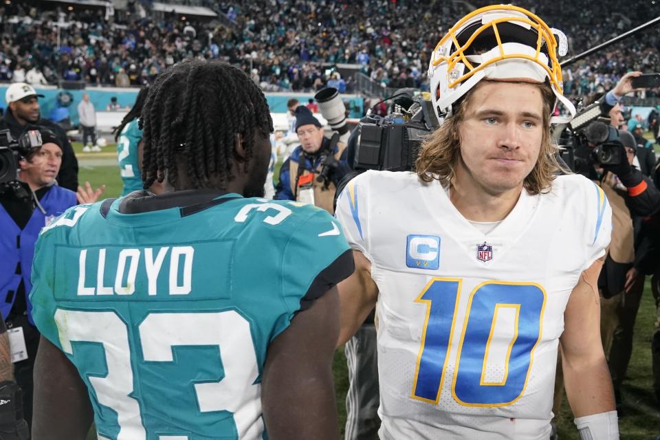 Los Angeles Chargers quarterback Justin Herbert (10) walks off the field after an NFL wild-card football game against the Jacksonville Jaguars, Saturday, Jan. 14, 2023, in Jacksonville, Fla. Jacksonville Jaguars won 31-30. (AP Photo/Chris Carlson)