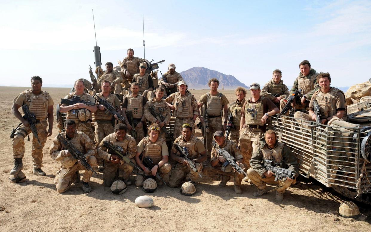 Prince Harry (fifth right) with Nathan Hunt (front right) in Helmand province in 2008 - PA Archive