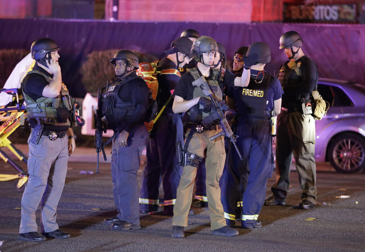 Police officers stand at the scene of a shooting near the Mandalay Bay resort and casino on the Las Vegas Strip (AP Photo/John Locher)