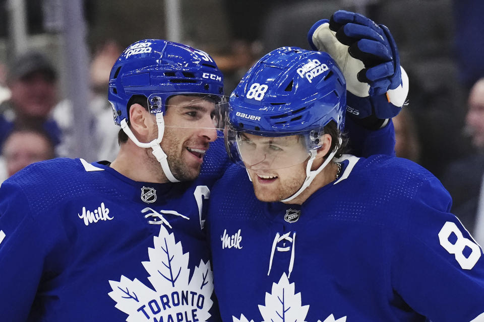 Toronto Maple Leafs forward John Tavares (91) celebrates his goal against the Dallas Stars with forward William Nylander (88) during the second period of an NHL hockey game Wednesday, Feb. 7, 2024, in Toronto. (Nathan Denette/The Canadian Press via AP)