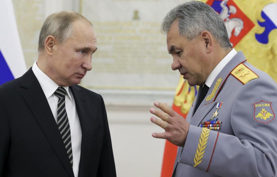 Russian President Vladimir Putin, left, listens to Defense Minister Sergei Shoigu during a meeting with senior military officers in Moscow, Russia, Wednesday, Nov. 6, 2019. Putin said Russia's new weapons have no foreign equivalents but he insists the country will not use them to threaten anyone. (Mikhail Klimentyev, Sputnik, Kremlin Pool Photo via AP)