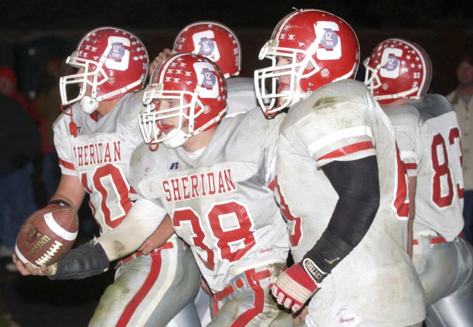 Kevin Culver (38) is escorted back onto the field by his team after scoring a touchdown against Steubenvlle during a 22-18 win in a Division III, Region 11 semifinal at Crater Stadium in Dover. Culver ran for three scores as the Generals upset the top-ranked Big Red for one of the biggest wins in program history.