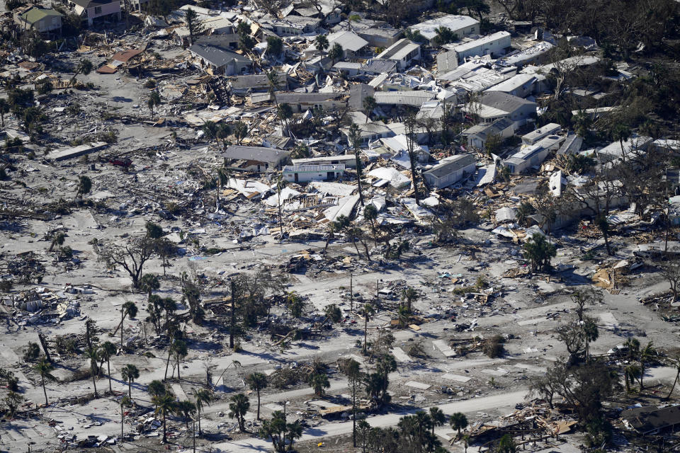 FILE - In a flight provided by mediccorps.org, debris from Hurricane Ian covers Estero Island in Fort Myers Beach, Fla., Sept. 30, 2022. Hurricane Ian confounded one key computer forecast model, creating challenges for forecasters and Florida residents. (AP Photo/Gerald Herbert, File)