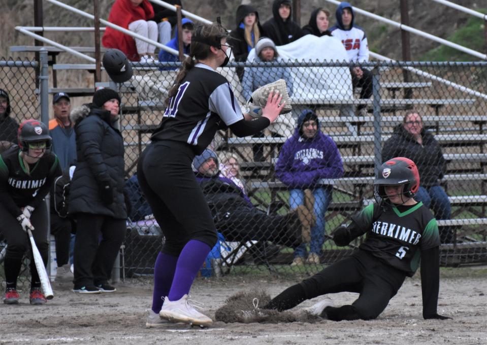 Herkimer Magician Leah Bray slides home safely after escaping a rundown Wednesday while Little Falls pitcher Makena Tooley (left) awaits a throw at Veterans Memorial Park.