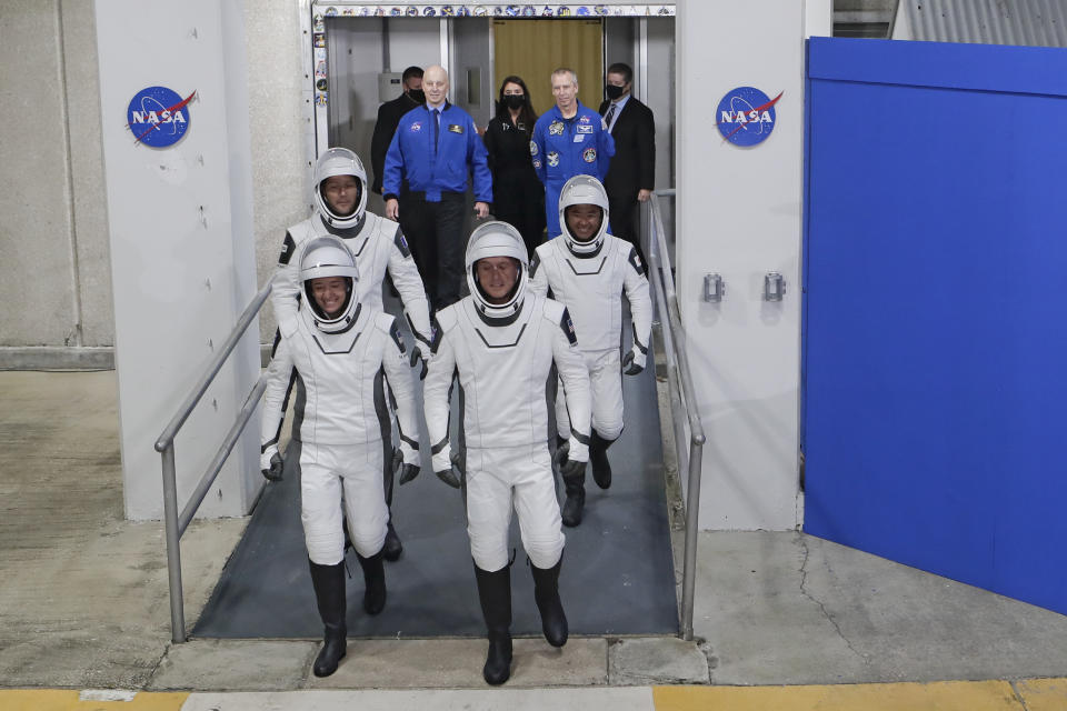 The Crew Dragon space capsule astronauts, from front left; NASA astronaut Megan McArthur, NASA astronaut Shane Kimbrough and back row European Space Agency astronaut Thomas Pesquet and Japan Aerospace Exploration Agency astronaut Akihiko Hoshide leave the Operation and Checkout Building on their way to board the capsule for a mission to the International Space Station at the Kennedy Space Center in Cape Canaveral, Fla., Friday, April 23, 2021. (AP Photo/John Raoux)