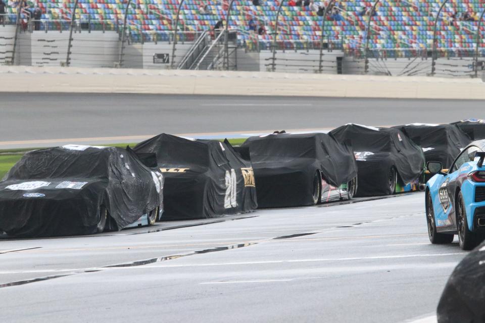 Cars remain covered as rain puts a stop to the running of the 63rd Daytona 500 at Daytona International Speedway on Sunday, Feb. 14, 2021.