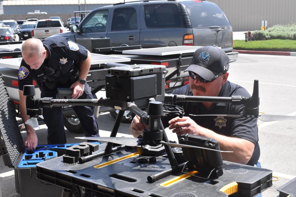 Salinas police officer Steve Hoyte (left) and Sargent Steve Sparks assemble a DJI Matrice drone.