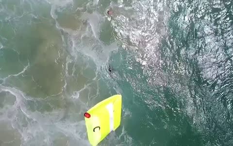 Two teenage boys sucked out to sea by a rip tide were saved from drowning by a drone, in what may be a world first - Credit:  Caters News Agency