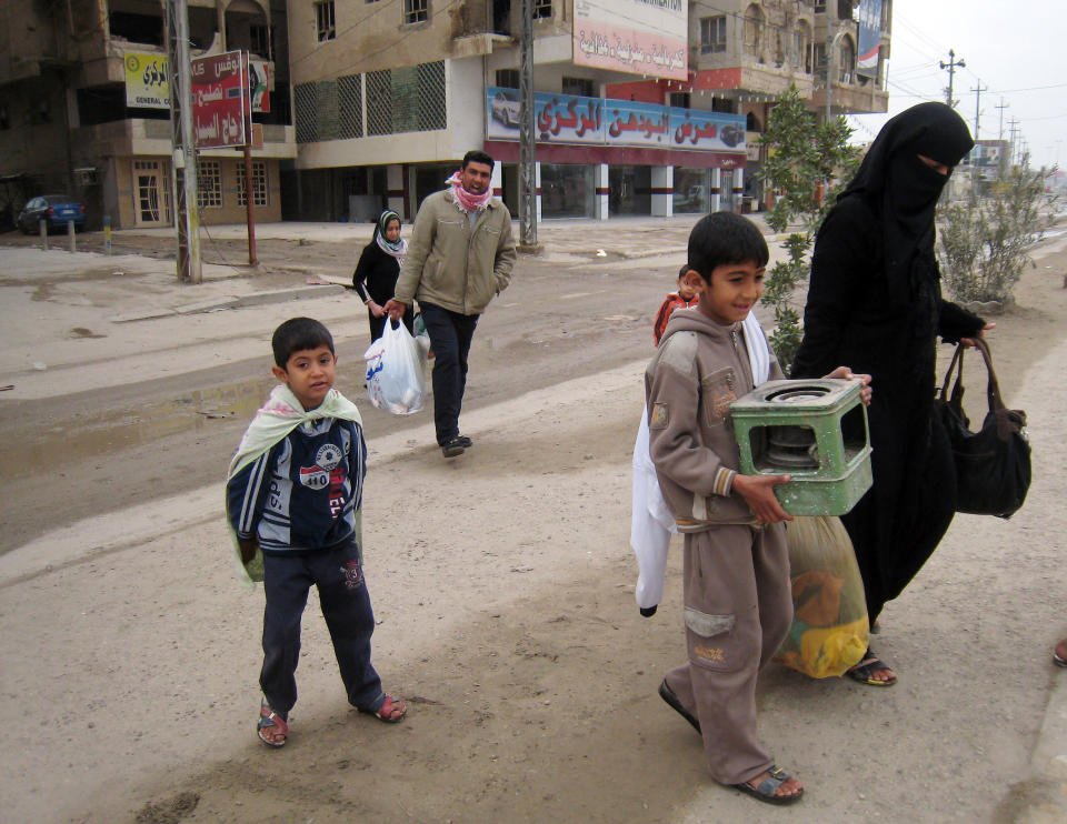 Civilians leave their home after clashes between the Iraqi army and al-Qaeda fighters in Fallujah, 40 miles (65 kilometers) west of Baghdad, Iraq, Sunday, Jan. 5, 2014. Lt. Gen. Rasheed Fleih, a senior Iraqi military commander said it will take a few days to fully dislodge al-Qaida-linked fighters from Fallujah and Ramadi. (AP Photo)