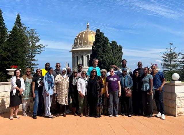 Rami Nashashibi, far right, and Rabbi Andrea C. London, front in purple, with their interfaith group visiting the Bahai Gardens in Haifa, Israel, before heading to the airport on Oct. 7, 2023. That's when a Hamas attack hit Israel, and the group had to hide in the airport bomb shelter: "We tried to comfort ourselves and others around us as we searched for a safe way home, eventually having to cross into Jordan to catch flights back to America."