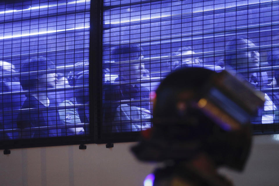 Detained protesters are seen in a police vehicle in Hong Kong on Sunday, Oct. 27, 2019. Hong Kongers rallied Sunday over concerns about police conduct in months long pro-democracy demonstrations, including exposing police dogs to tear gas during chaotic confrontations with protesters. (AP Photo/Kin Cheung)