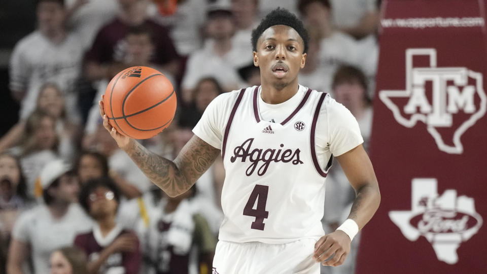 FILE - Texas A&M guard Wade Taylor IV (4) brings the ball down court during the first half of an NCAA college basketball game against Alabama, Saturday, March 4, 2023, in College Station, Texas. (AP Photo/Sam Craft, File)