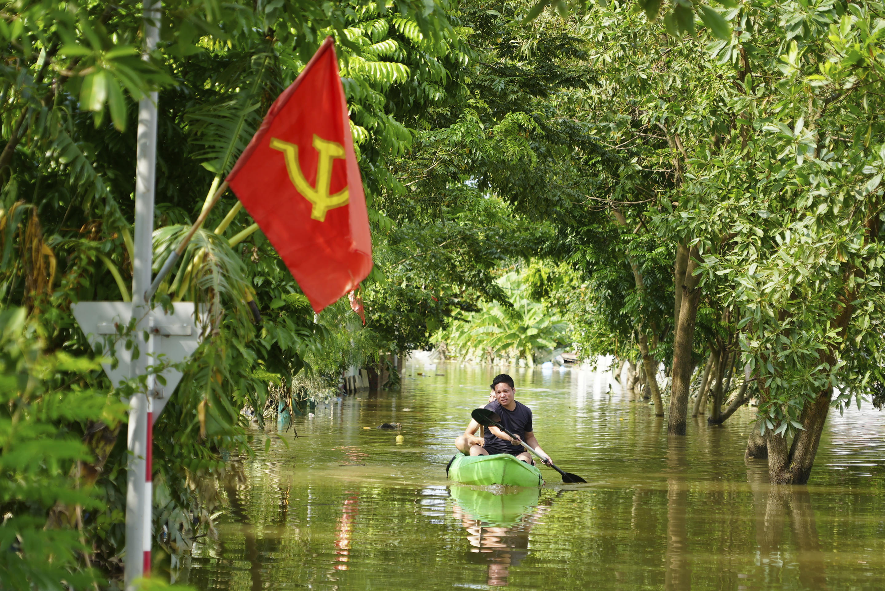 A man paddles a boat in the flood in the aftermath of Typhoon Yagi in An Lac village, Hanoi, Vietnam Friday, Sept. 13, 2024. (Hau Dinh/AP)