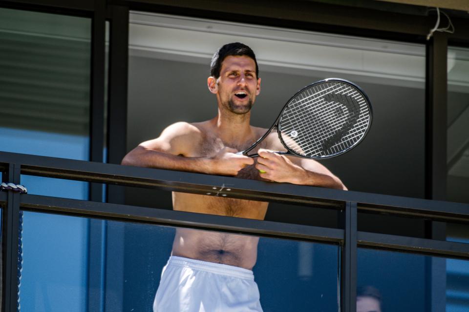 World No.1 Novak Djokovic responds to fans from a hotel balcony in Adelaide during quarantine.