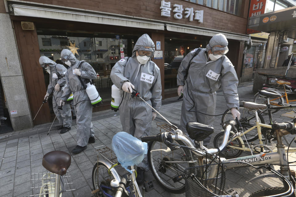 South Korean army soldiers spray disinfectant as a precaution against the new coronavirus on a street in Seoul, South Korea, Friday, March 6, 2020. South Korea's premier has criticized Japan's 14-day quarantine on all visitors from South Korea due to its viral outbreak, demanding that Tokyo immediately withdraw the "excessive and irrational measures." (AP Photo/Ahn Young-joon)