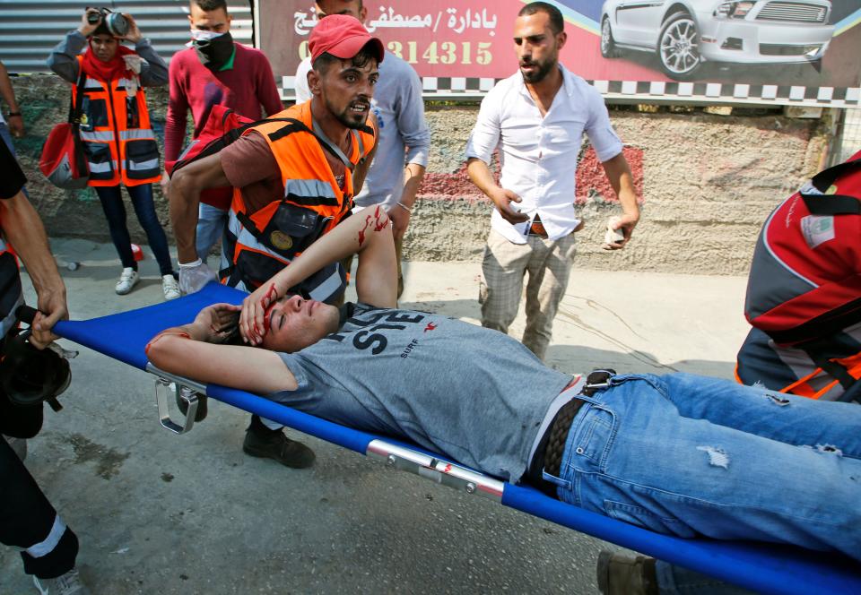 <p>Rescuers carry a wounded protester away from the scene of a protest in Ramallah, in the occupied West Bank, on May 15, 2018. -Palestinians marked the Nakba, or “catastrophe”, commemorating the more than 700,000 Palestinians who fled or were expelled in the 1948 war surrounding Israel’s creation. (Photo: Abbas Momani/AFP/Getty Images) </p>