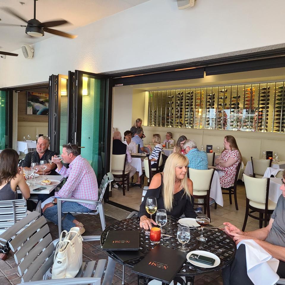 Dining al fresco under a shaded terrace is one of four seating options at Nosh on Naples Bay. Others include patio adjacency, the bar and near the open kitchen.