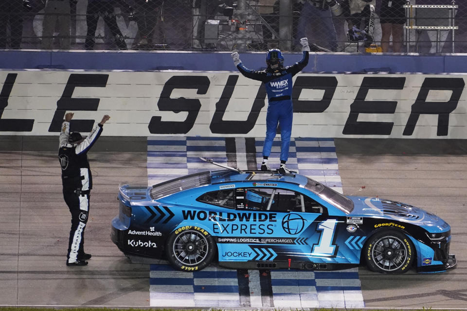 Ross Chastain celebrates atop his car after winning a NASCAR Cup Series auto race, late Sunday, June 25, 2023, in Lebanon, Tenn. (AP Photo/George Walker IV)