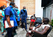 In this photo released by the Lagos State government press, governor Babajide Sanwo-Olu, centre, visit victims injured in last night's protests in a hospital in Lagos, Nigeria, Wednesday Oct. 21, 2020. Nigerians protesting against police brutality stayed on the streets in Lagos on Wednesday, breaking the government curfew following a night of chaotic violence in which demonstrators were fired upon, sparking global outrage. (Lagos State government press Via AP)