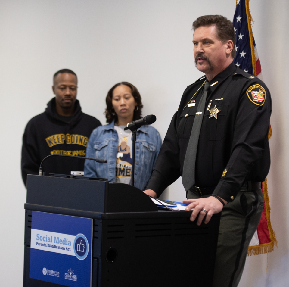 Portage County Sheriff Bruce Zuchowski talks about the growing threat of sextortion as Streetsboro residents Tim and Tamia Woods listen. The Woods' 17-year-old son died by suicide after he became a sextortion victim last year.