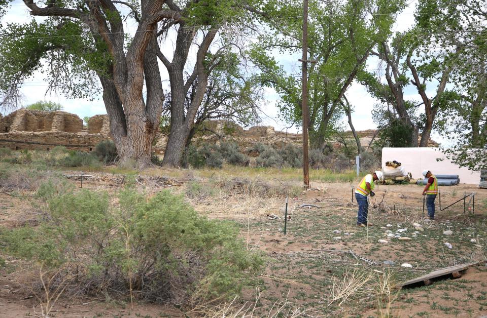 Workers install fencing around a section of Aztec Ruins National Monument that has been designated for a landscape restoration project on Thursday, May 16 in Aztec.
