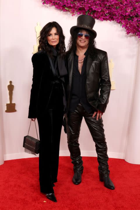 HOLLYWOOD, CALIFORNIA – MARCH 10: (L-R) Meegan Hodges and Slash attend the 96th Annual Academy Awards on March 10, 2024 in Hollywood, California. (Photo by John Shearer/WireImage)