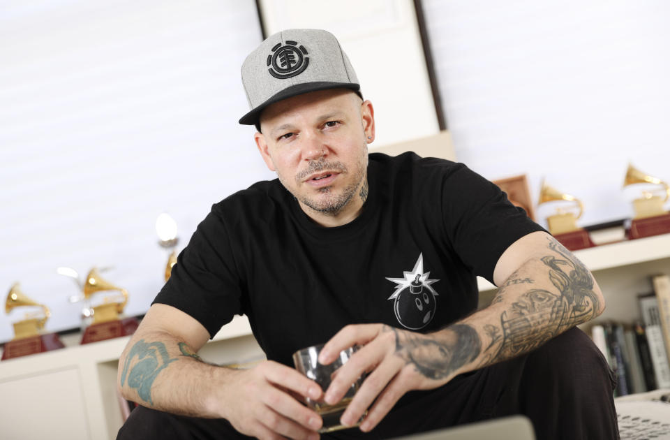 This July 12, 2019 photo shows Puerto Rican rapper, writer, and filmmaker René Pérez Joglar, known professionally as Residente, at his home in New York. Residente studied intensely with professors at Yale University and New York University to create his second solo project. The untitled album will be released in November. (Photo by Brian Ach/Invision/AP)