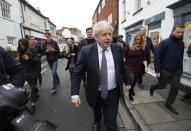 Britain's Prime Minister Boris Johnson walks through High Street during a General Election campaign trail stop in Wells, England, Thursday, Nov. 14, 2019. Britain goes to the polls on Dec. 12. (AP Photo/Frank Augstein, Pool)