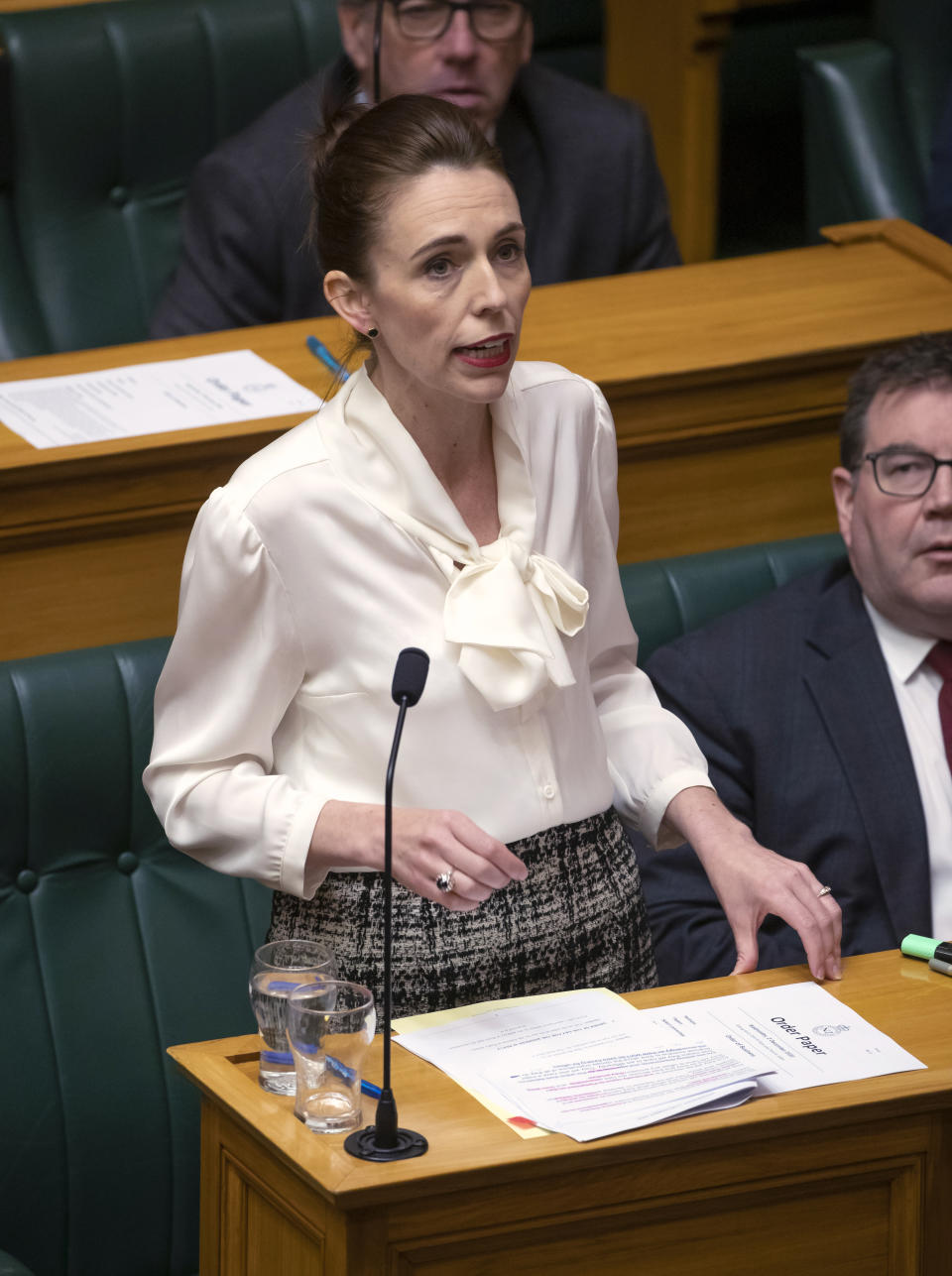 New Zealand's Prime Minister Jacinda Ardern moves a motion in the Parliament House in Wellington, New Zealand, to declare a climate emergency, Wednesday, Dec. 2, 2020. Joining more than 30 other countries around the world, New Zealand took the symbolic step of declaring a climate emergency. (Mark Mitchell/New Zealand Herald via AP)